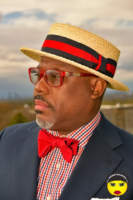 Guest in a straw boater and red bow tie at the 2026 Kentucky Derby Day Party in Boston