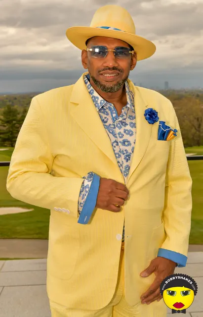 Guest in a yellow suit and matching straw hat at the 2026 Kentucky Derby Day Party in Boston