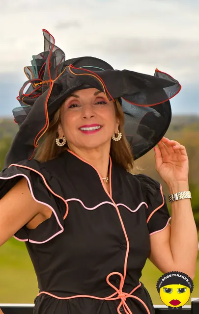 Guest in a black ruffled hat with coral trim at the 2026 Kentucky Derby Day Party in Boston
